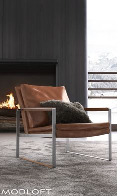 a brown chair sitting in front of a fire place