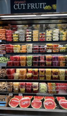 a display in a grocery store filled with lots of fruits and vegtables