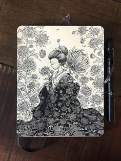 a black and white drawing of a woman with flowers in her hair on top of a wooden table