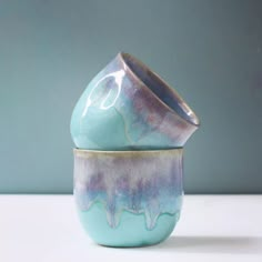 a blue and purple vase sitting on top of a table