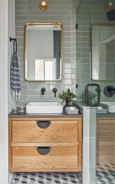 a bathroom with a sink, mirror and tiled floor