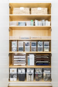 an organized closet with shelves and bins