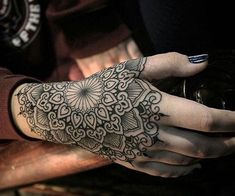 a woman's hand with a tattoo on it