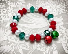 "✿ Beautiful Christmas bracelet in an easy to wear strong stretchy cord. Simply elegant! ✿ Strung within 8 mm smooth glass pearl beads and multi-faceted crystal beads the focal point of this piece are red and green \"Jingle\" bells. The multi-faceted crystals catch the light at your every move, stunning! ✿ This item comes in a dainty sheer organza drawstring pouch, ready for gift-giving. ✿ Gift box with personalized card available through this link: http://www.etsy.com/listing/94969233/ ✿ Averag Adjustable Red Stretch Bracelet For Holiday, Red Adjustable Stretch Bracelet For Holidays, Adjustable Stretch Bracelet Gift For Christmas, Adjustable Red Bracelet For Christmas, Red Stretch Bracelet For Christmas, Red Stretch Bracelet For Christmas Holiday, Christmas Jewelry Diy, Pony Bead Bracelets, Christmas Bling