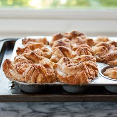 a pan filled with pastries sitting on top of a counter