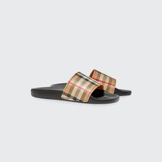 Burberry "Mini Furley" pool slide sandals with check printed upper. One-band upper. Logo embossed platform. Molded footbed. Slip-on style. Rubber outsole. Upper: thermoplastic polyurethane. Imported. Designer Beach Slides With Cushioned Footbed, Designer Slides For Summer, Luxury Slide Sandals For Beach, Luxury Beach Slide Sandals, Luxury Textured Slides For Summer, Designer Summer Slides With Cushioned Footbed, Luxury Sport Sandals With Round Toe For Summer, Designer Round Toe Slides For Summer, Luxury Summer Slides With Rubber Sole