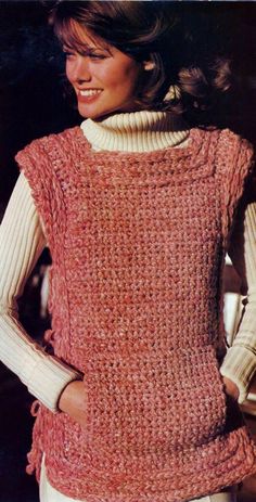 a woman is wearing a sweater made out of knitted yarn and has her hands on her hips