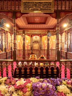 an elaborately decorated room with flowers in the foreground