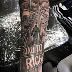 a man's leg with a road to riche tattoo on it