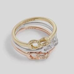 Coach Interlock Signature Pave Crystals Ring Set - Set Of 3 Pieces - Stackables Size 7 Gold, Rose Gold, Silver Stackable Ring Set In Neutral Tri-Tone Plating Featuring Interlocking Signature Sculpted C-Links At Front Adorned With Minimal Pave. Fast Shipping Welcome Offers & Counteroffers Item Stored In A Smoke-Free And Pet-Free Environment. Feel Free To Send Me Any Questions. Please Review All Photos And Zoom In To See The Exact Condition, Details, And Measurements. Idiomas/Languages: Espaol / E Crystals Ring, Pave Setting Ring, Halo Ring Setting, Signature Rings, Stackable Ring Sets, Stackable Rings Silver, Gold Heart Ring, Coach Jewelry, Feather Ring