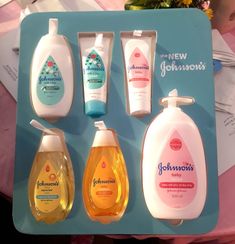 four different types of hand soaps on a blue tray