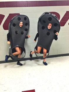 two people in black bodysuits with holes on them