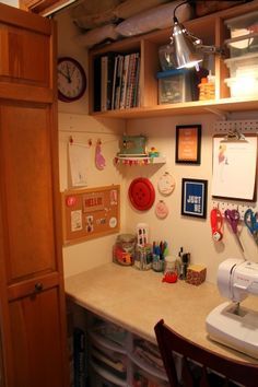 a sewing machine sitting on top of a counter next to a wooden shelf filled with craft supplies