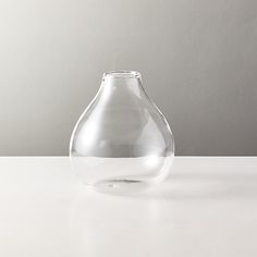 a clear vase sitting on top of a white table