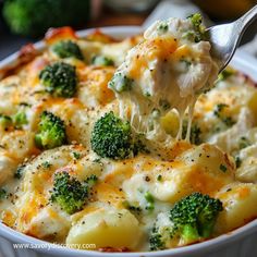 broccoli and cheese casserole being lifted with a fork from a dish