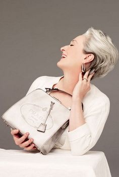 black and white photograph of a woman talking on the phone while holding a handbag