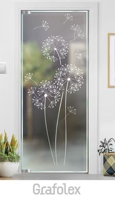 a glass door with dandelions drawn on it