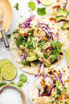 three chicken tacos with cabbage, avocado and cilantro