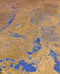 a close up view of blue and gold paint