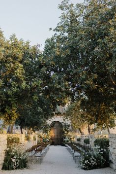 an outdoor ceremony set up with chairs and flowers