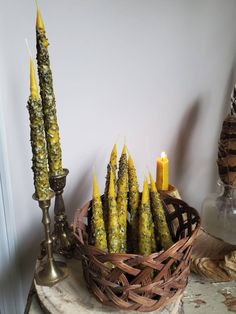 some candles are sitting in a basket on a table