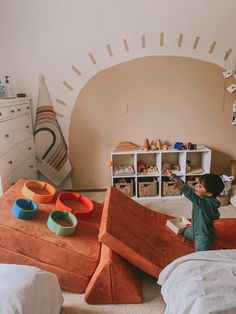 a young boy is playing in his bedroom