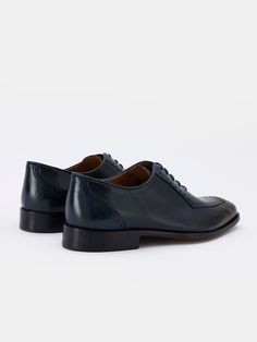 Color: navy Calf leather with natural finish Leather insoles Rubber and leather soles Traditional lace-up closure Hand-stitched detailing Goodyear Welted Calf Leather Lace-up Shoes, Timeless Goodyear Welted Leather Lace-up Shoes, Classic Navy Oxfords With Plain Toe, Blue Leather Sole Oxfords For Business Casual, Classic Navy Oxfords For Business, Classic Navy Wingtip Dress Shoes, Classic Navy Dress Shoes With Leather Sole, Classic Navy Plain Toe Dress Shoes, Classic Calf Leather Lace-up Shoes With Leather Footbed