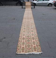 a long rug is laying on the sidewalk