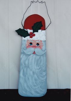 a glass santa clause is hanging on the wall