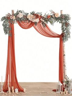 an orange wedding arch decorated with flowers and greenery