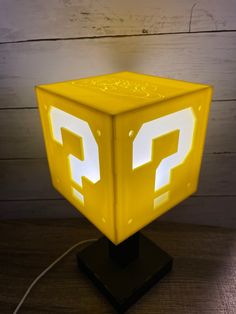 a lamp that looks like a cube with the letter p on it's face