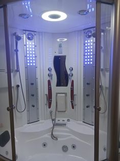 a large white bath tub sitting inside of a bathroom next to a walk in shower