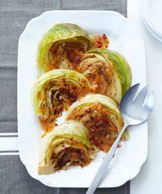 a white plate topped with cabbage covered in sauce