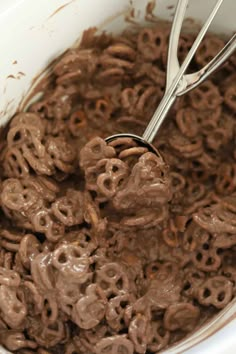 a bowl full of chocolate cereal with a spoon in it