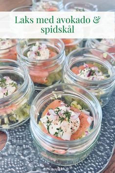 several small jars filled with food on top of a table