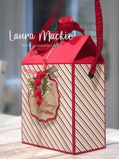 a small red and white gift bag on a table