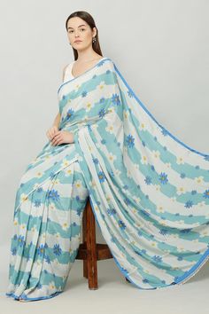 Blue saree with blooming floral print in stripe pattern. Comes along with an unstitched blouse fabric.
Components: 2
Pattern: Print
Type Of Work: Floral
Fabric: Crepe
Color: Blue
Other Details: 
Note: The stitched blouse worn by the model is not for sale
Occasion: Mehendi and Haldi - Aza Fashions Floral Print Sarees, Blue Saree, Printed Sarees, Blouse Fabric, Not For Sale, Sarees Online, Blue Print, Floral Fabric, Aza Fashion