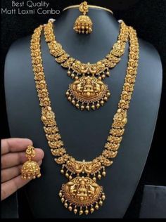 a gold necklace and earrings set on display