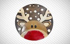 a wooden reindeer ornament hanging on a wall