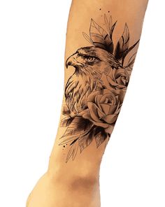 an eagle and rose tattoo on the leg