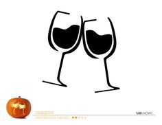 two glasses of wine sitting on top of a table next to a jack - o'- lantern