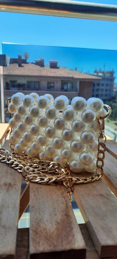 ✨ White Pearl Bag ✨ Meet our exquisite White Pearl Bag, a true embodiment of elegance and sophistication. This beauty is meticulously handmade with lustrous white pearls, ensuring that you shine with every step. Perfect for weddings, parties, or any special occasion where you want to make a statement. The luxurious gold chain adds a touch of glamour, making it a chic accessory for any outfit. Lightweight and stylish, this bag is your go-to for adding a hint of classic charm to your ensemble. 🌟👛 Elegant White Bags With Pearl Chain, Elegant Gold Bag With Pearl Chain, Elegant Bags With Pearl Chain For Gift, Gold Pearl Rectangular Evening Bag, Gold Rectangular Pearl Evening Bag, Rectangular Gold Pearl Evening Bag, Formal Pearl White Beaded Shoulder Bag, Gold Rectangular Bag With Pearl Material, Elegant Gold Shoulder Bag With Pearl Embroidery