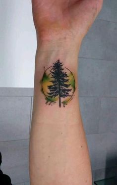 a small pine tree tattoo on the wrist