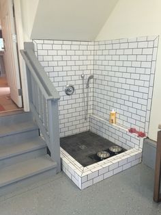 a bathroom with a tiled floor and stairs