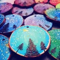 painted wooden slices with trees on them