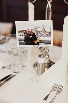 a table topped with silverware and pictures on top of it