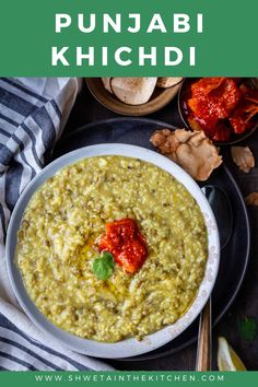 a bowl filled with green soup next to other foods