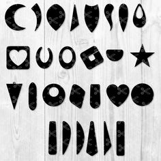 some cut out letters and numbers on a white wooden background with black accents, such as hearts