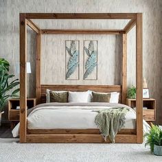 a bedroom with a four poster bed and two planters on either side of the bed