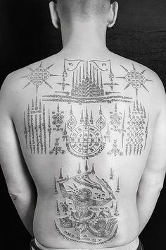 the back of a man with tattoos on his body